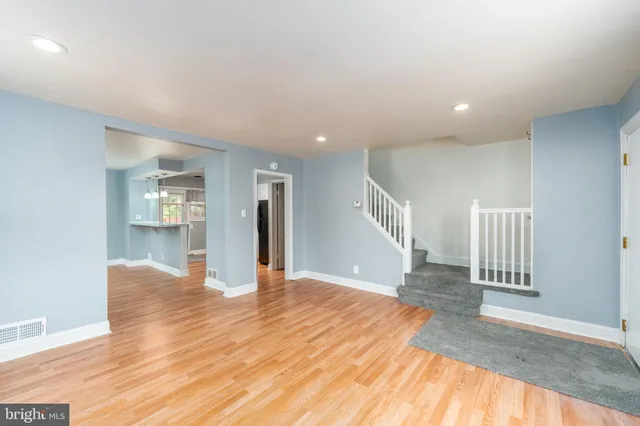 a view of empty room with wooden floor