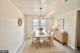 14905 Cleese Court, Unit E Silver Spring, MD 20906 - Photo 4 of 10 a dining room with furniture a chandelier and window