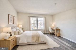 14905 Cleese Court, Unit E Silver Spring, MD 20906 - Photo 8 of 10 a bedroom with a bed and a table