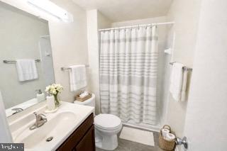 14905 Cleese Court, Unit E Silver Spring, MD 20906 - Photo 9 of 10 a bathroom with a sink vanity mirror and toilet