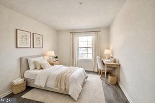 14905 Cleese Court, Unit E Silver Spring, MD 20906 - Photo 10 of 10 a bedroom with a bed and wooden floor