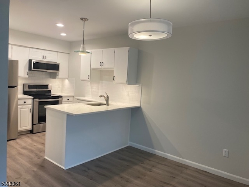 8 Larkspur Court Bedminster, NJ 07921 - Photo 3 of 19 a kitchen with kitchen island a sink stainless steel appliances and cabinets