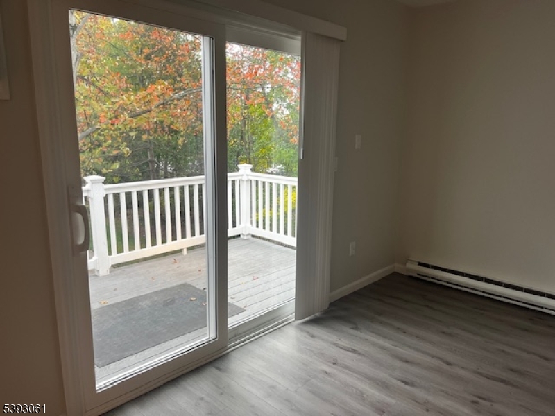 8 Larkspur Court Bedminster, NJ 07921 - Photo 7 of 19 an empty room with wooden floor and windows