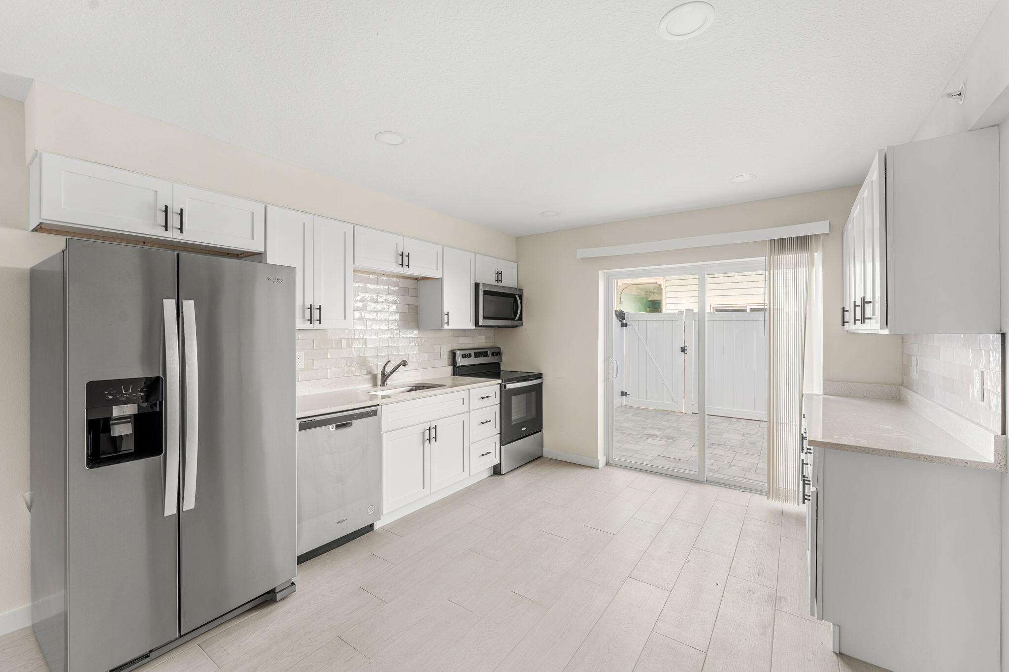 122 Central Road, Unit 105 Indian Harbour Beach, FL 32937 - Photo 4 of 15 a kitchen with stainless steel appliances a refrigerator sink and cabinets