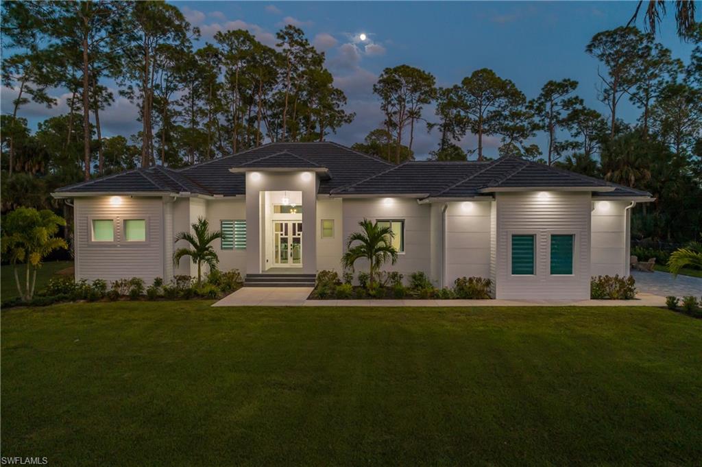 a view of a house with a yard and garden