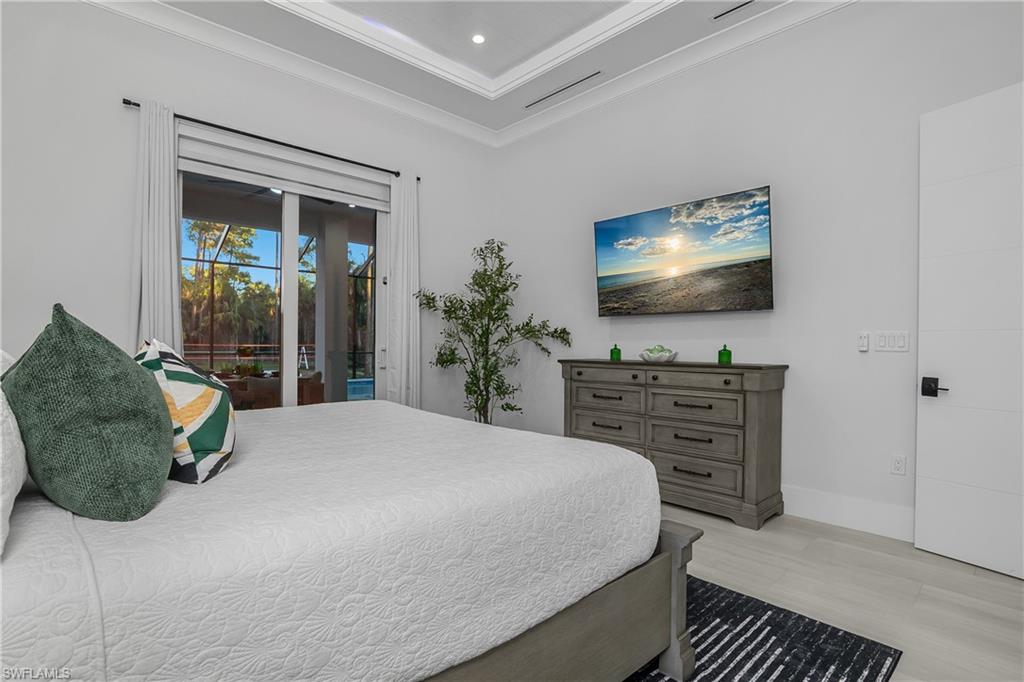 788 9th Street Southwest Naples, FL 34117 - Photo 12 of 46 a bedroom with a bed and a flat screen tv