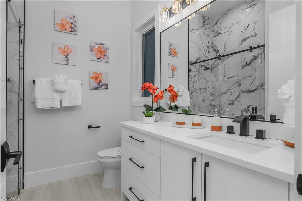 788 9th Street Southwest Naples, FL 34117 - Photo 18 of 46 a bathroom with a sink a toilet and a shower curtain