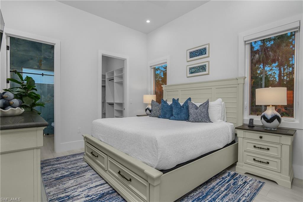 788 9th Street Southwest Naples, FL 34117 - Photo 19 of 46 a bedroom with a bed and a potted plant on dresser
