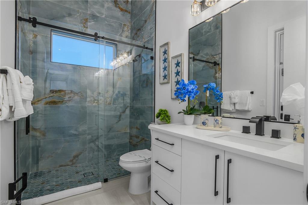 788 9th Street Southwest Naples, FL 34117 - Photo 20 of 46 a bathroom with a shower sink vanity mirror and toilet