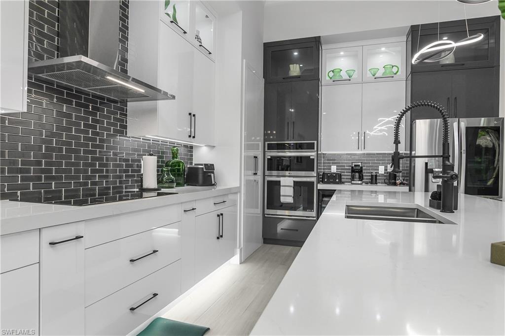 788 9th Street Southwest Naples, FL 34117 - Photo 24 of 46 a kitchen with stainless steel appliances kitchen island granite countertop a sink and cabinets