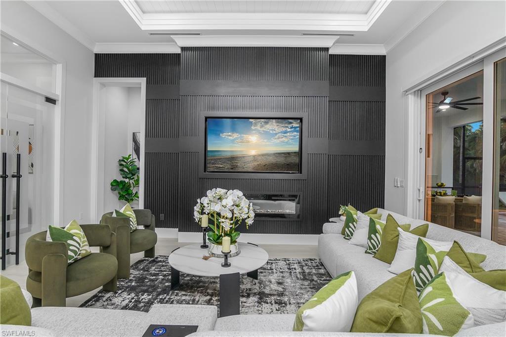 788 9th Street Southwest Naples, FL 34117 - Photo 30 of 46 a living room with furniture and a flat screen tv
