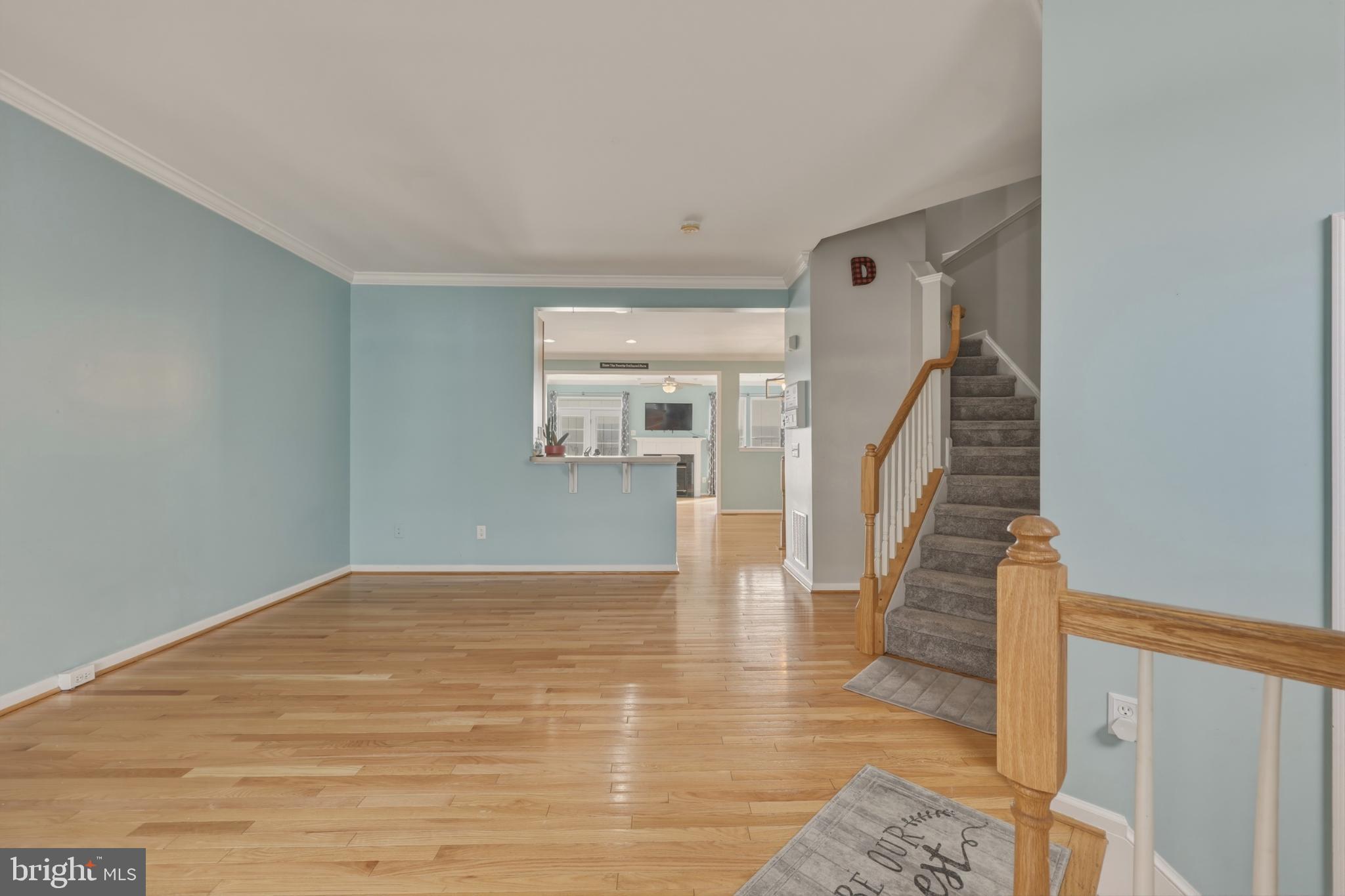 148 Riparian Lane Ranson, WV 25438 - Photo 6 of 41 Spacious entryway with serene blue walls.