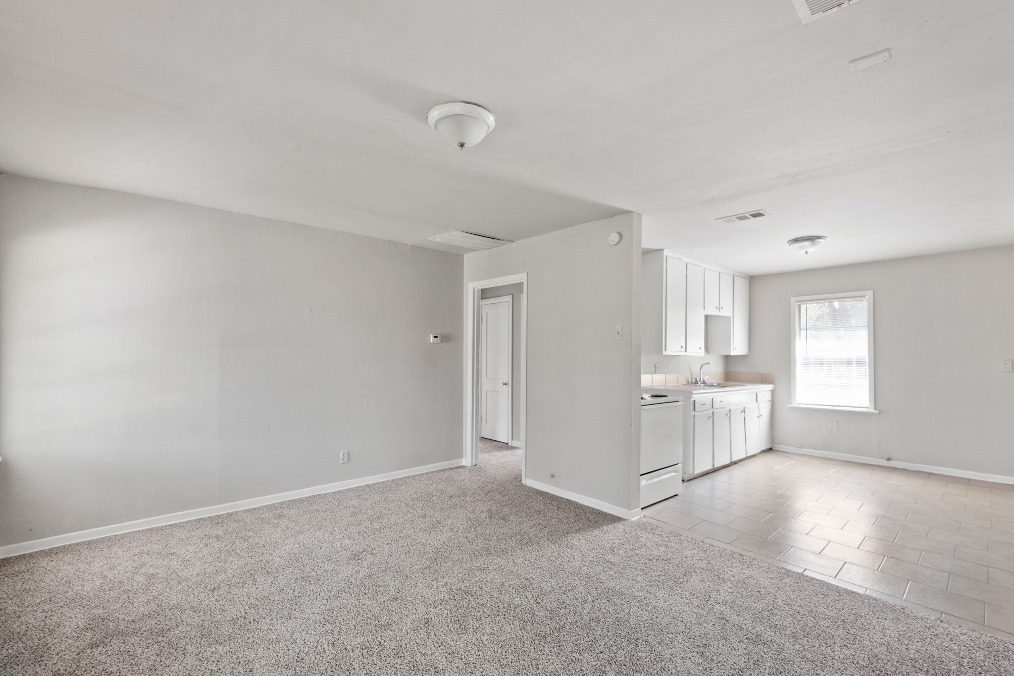 4922 Alvin Street Houston, TX 77033 - Photo 8 of 10 a view of a livingroom and a kitchen