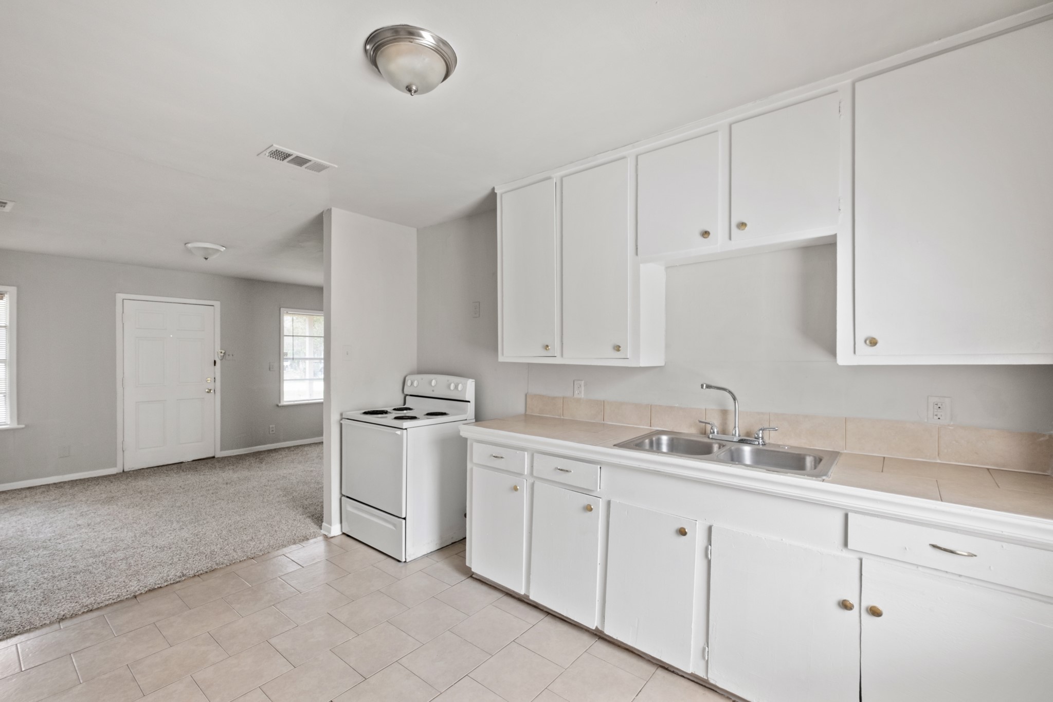 4922 Alvin Street Houston, TX 77033 - Photo 9 of 10 a kitchen with cabinets appliances and a sink