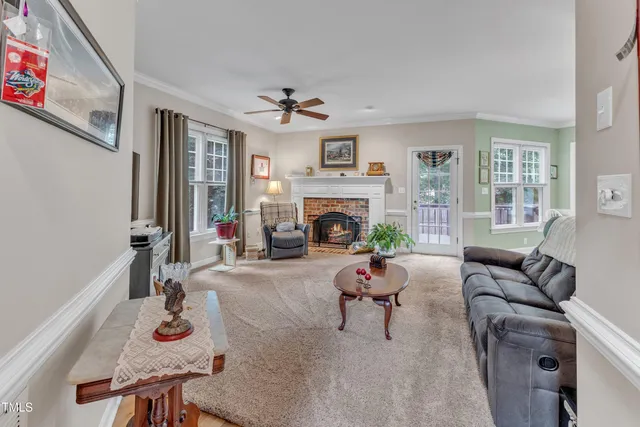 a living room with furniture fireplace and a flat screen tv