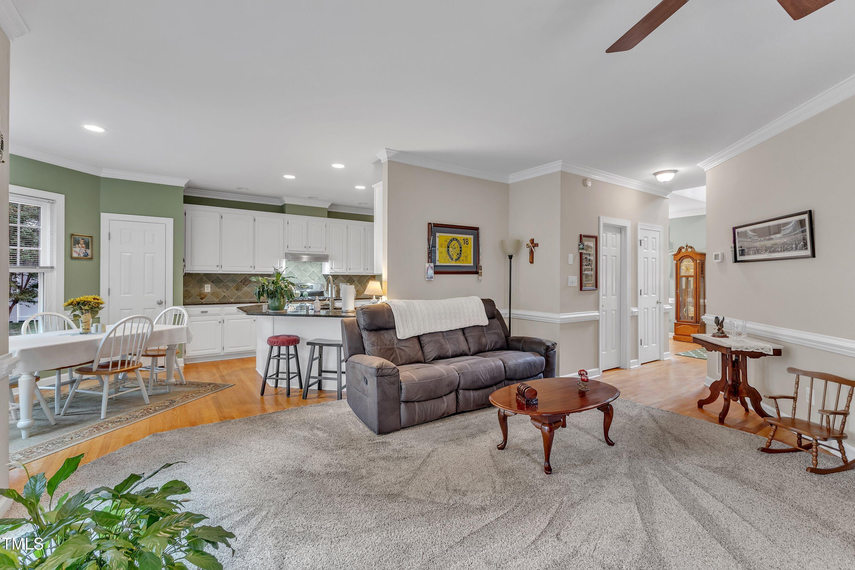 7613 Percy Court Raleigh, NC 27613 - Photo 15 of 51 a living room with furniture and a dining table with kitchen view