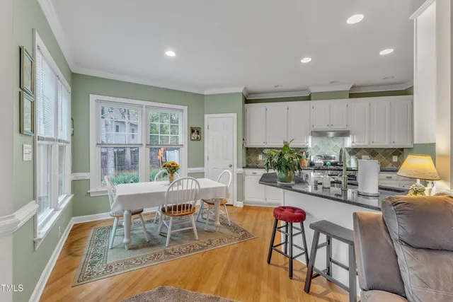 a living room with furniture and a dining table with kitchen view