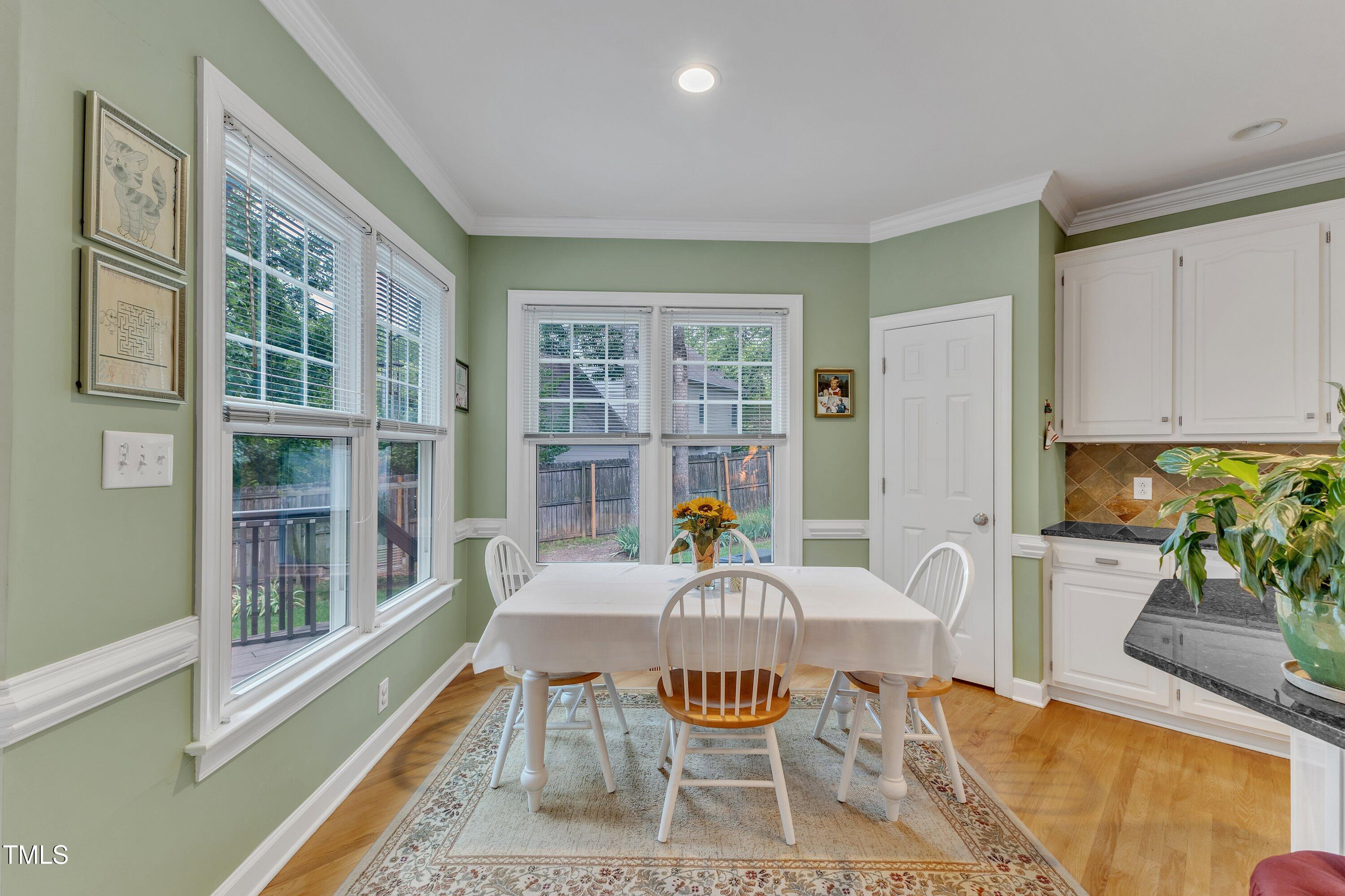 7613 Percy Court Raleigh, NC 27613 - Photo 18 of 51 a view of a dining room with furniture window and wooden floor