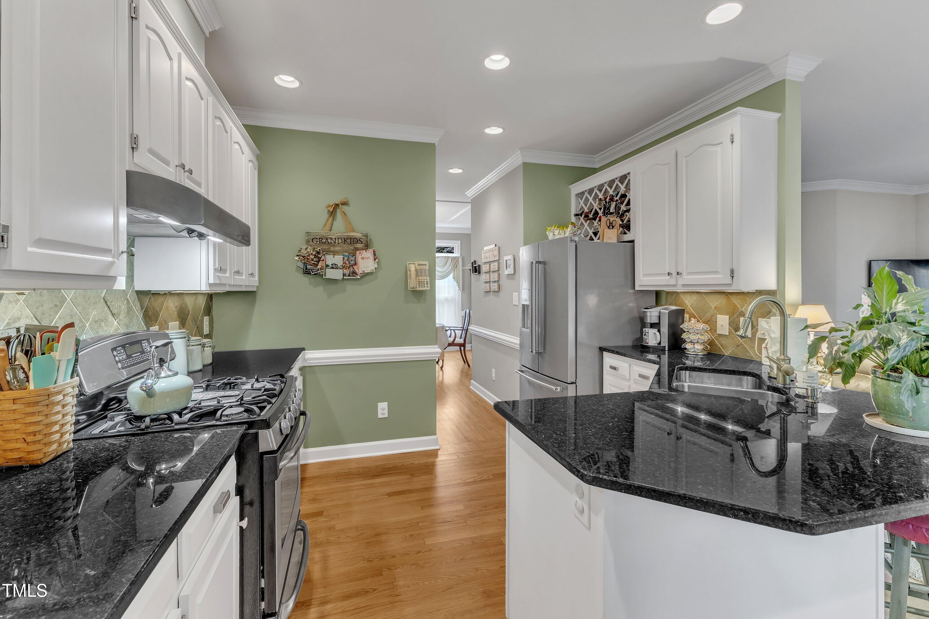 7613 Percy Court Raleigh, NC 27613 - Photo 23 of 51 a kitchen with stainless steel appliances granite countertop a sink stove and refrigerator