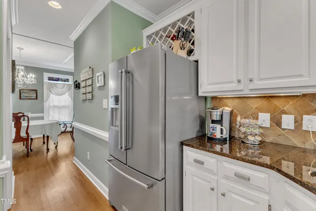 a kitchen with stainless steel appliances a refrigerator and cabinets