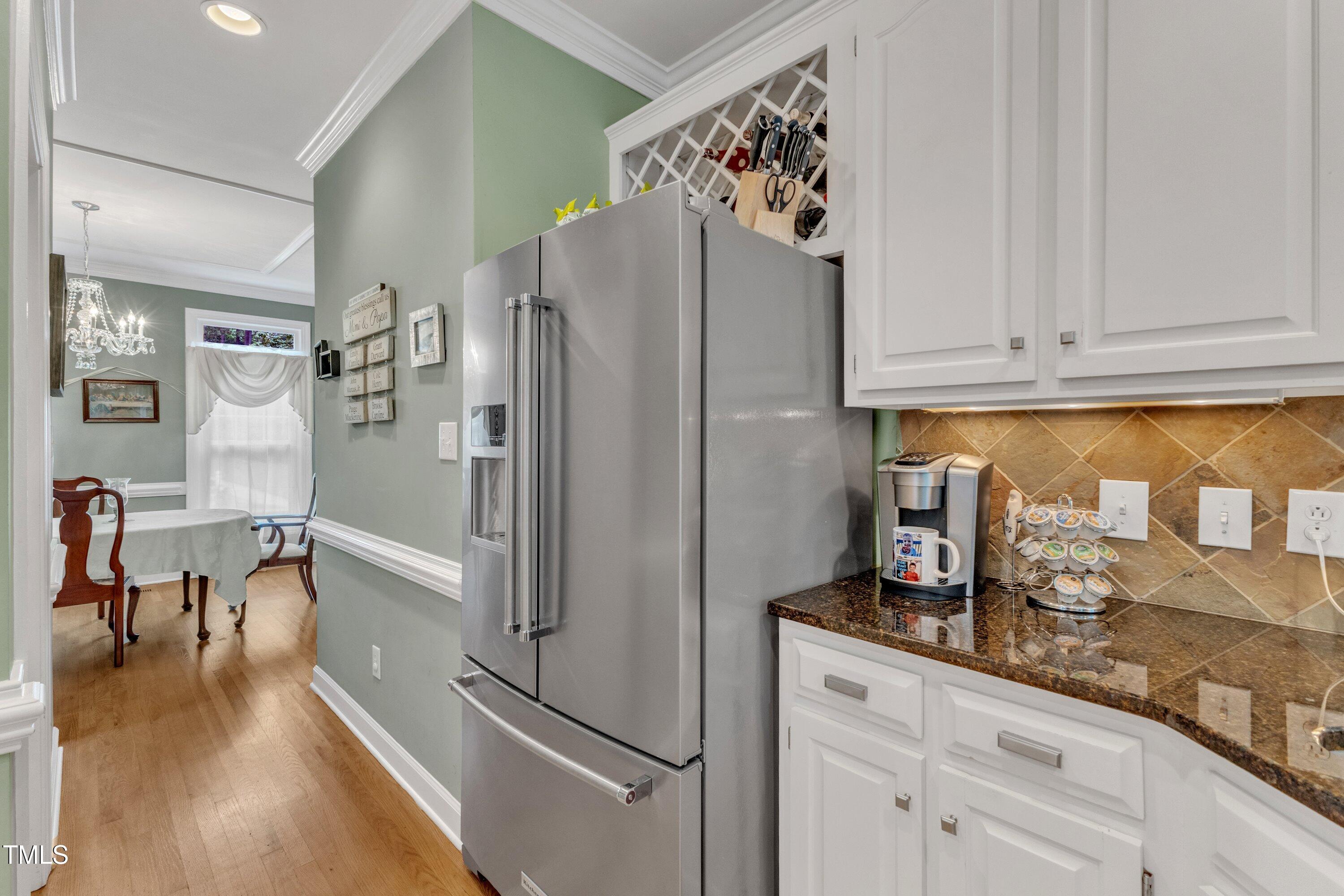 7613 Percy Court Raleigh, NC 27613 - Photo 26 of 51 a kitchen with stainless steel appliances a refrigerator and cabinets