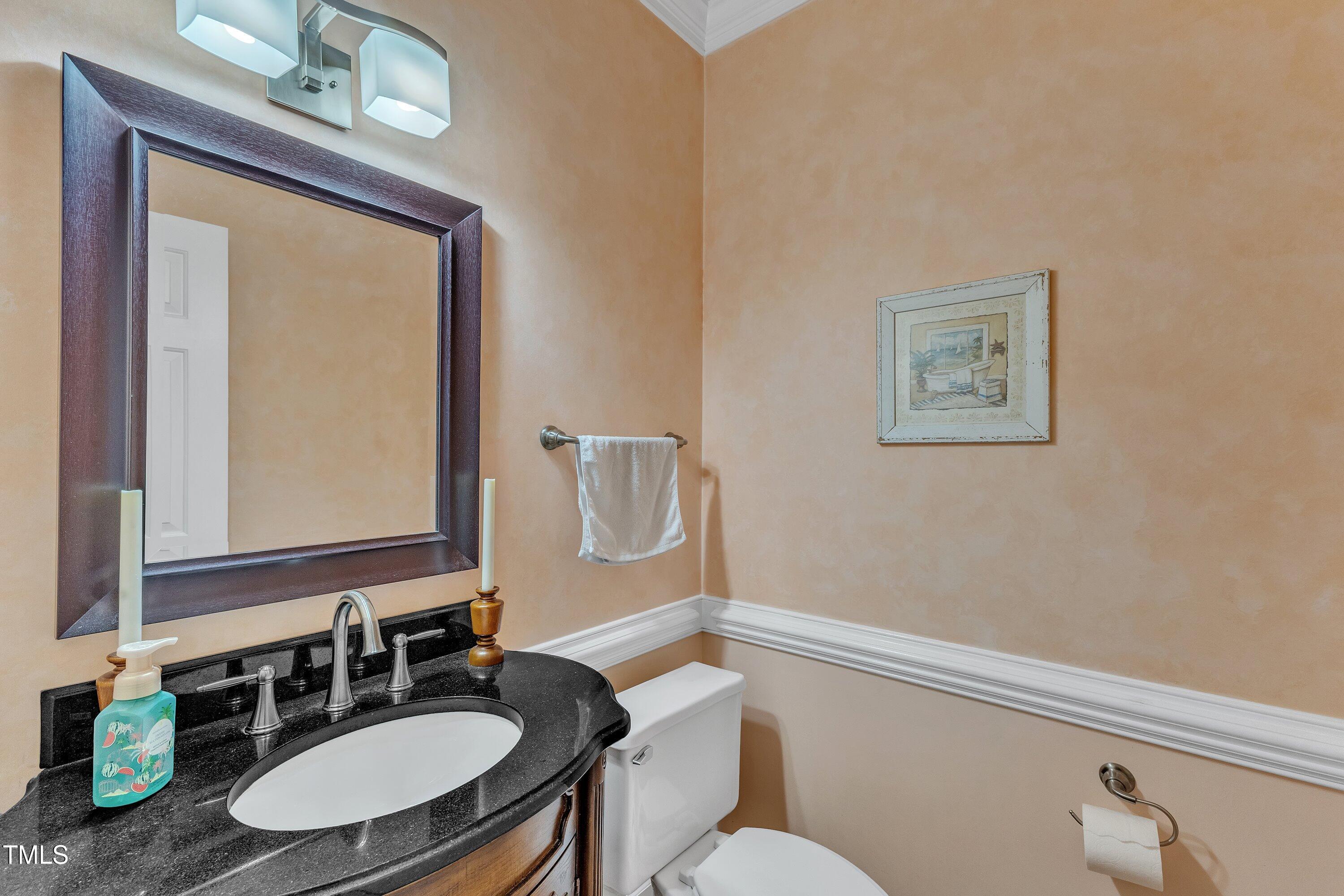 7613 Percy Court Raleigh, NC 27613 - Photo 27 of 51 a bathroom with a sink vanity mirror and toilet