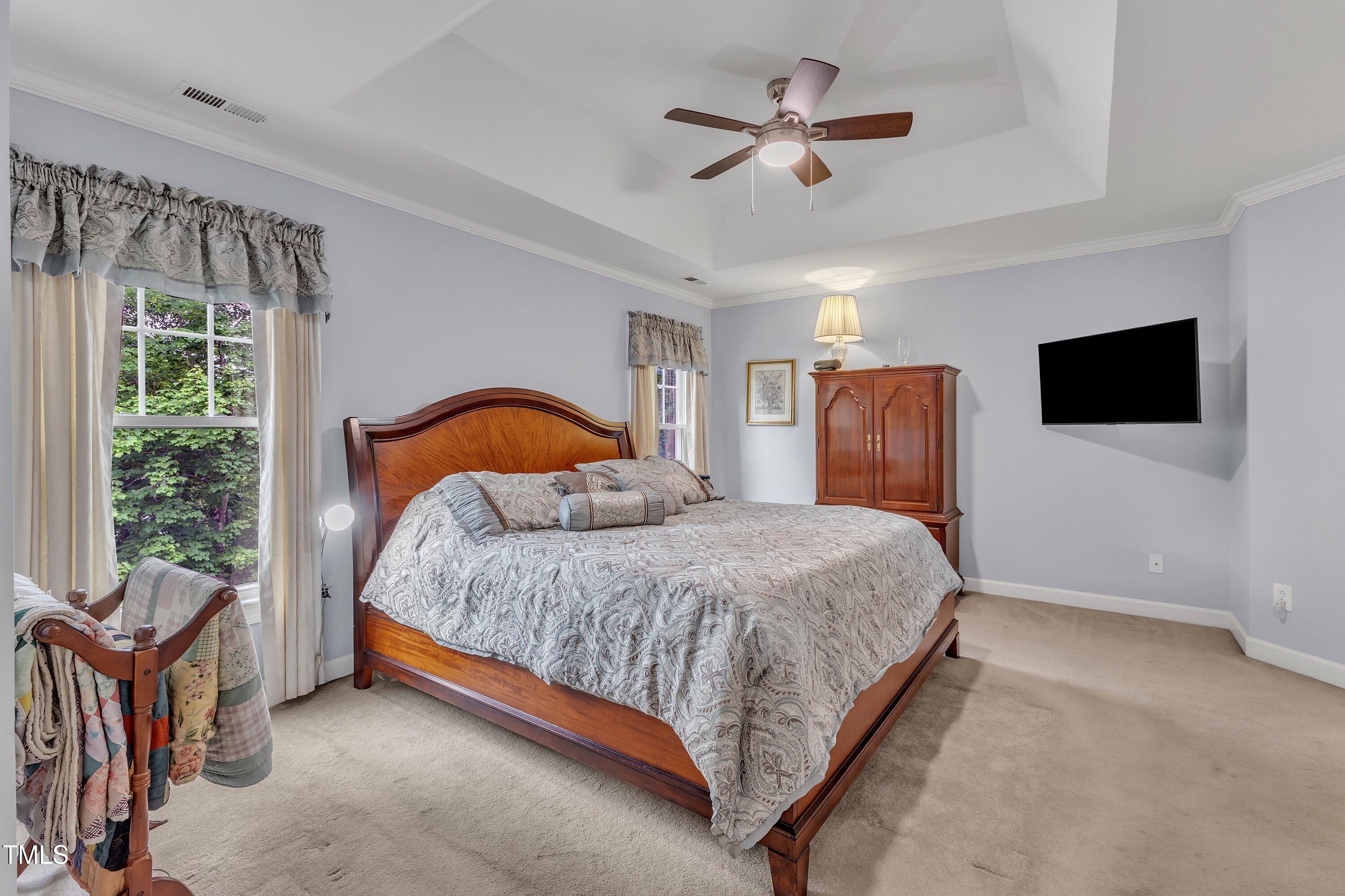 7613 Percy Court Raleigh, NC 27613 - Photo 29 of 51 a bedroom with a bed window and a flat screen tv