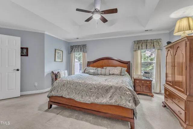 a bedroom with a bed dresser and a window