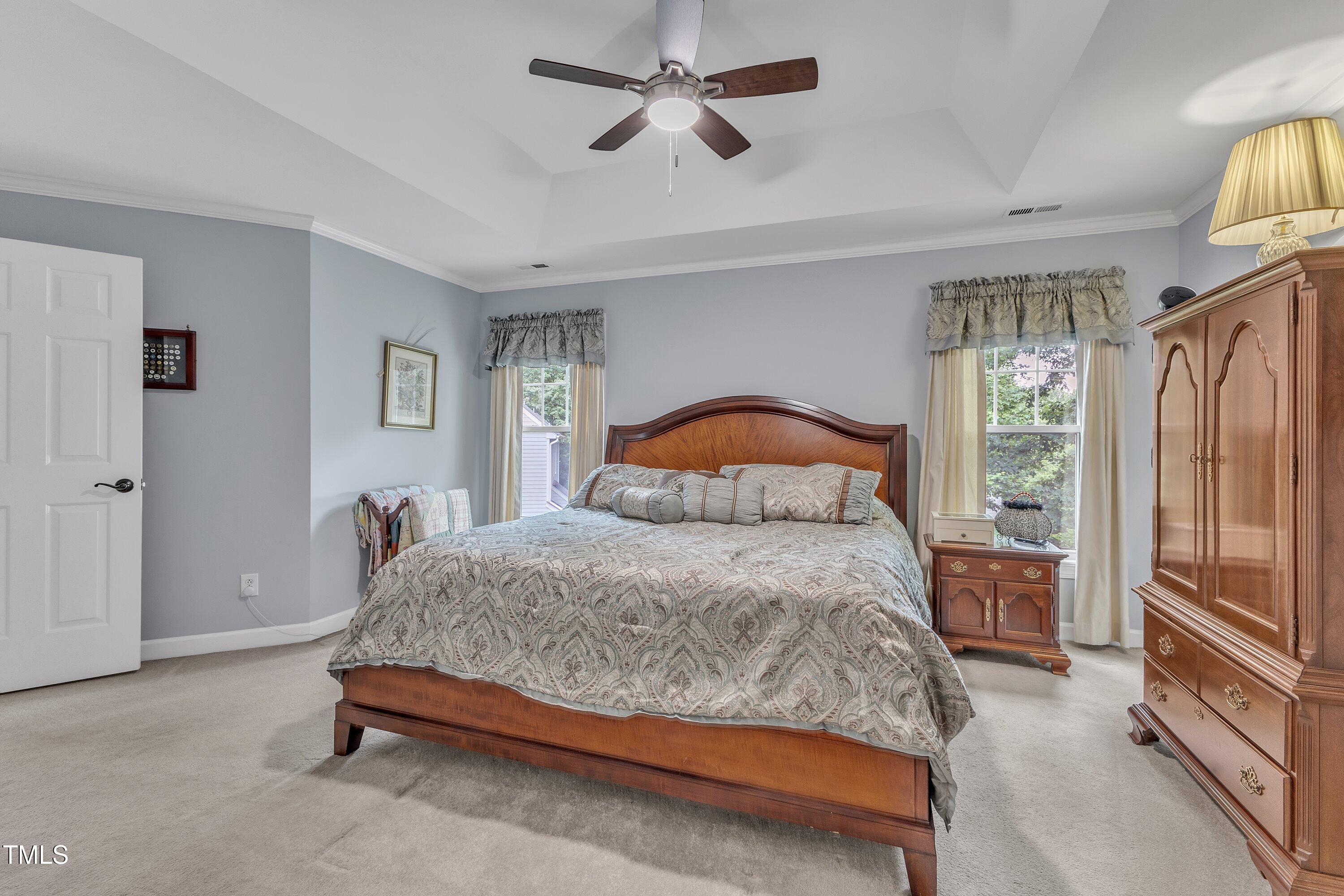 7613 Percy Court Raleigh, NC 27613 - Photo 30 of 51 a bedroom with a bed dresser and a window