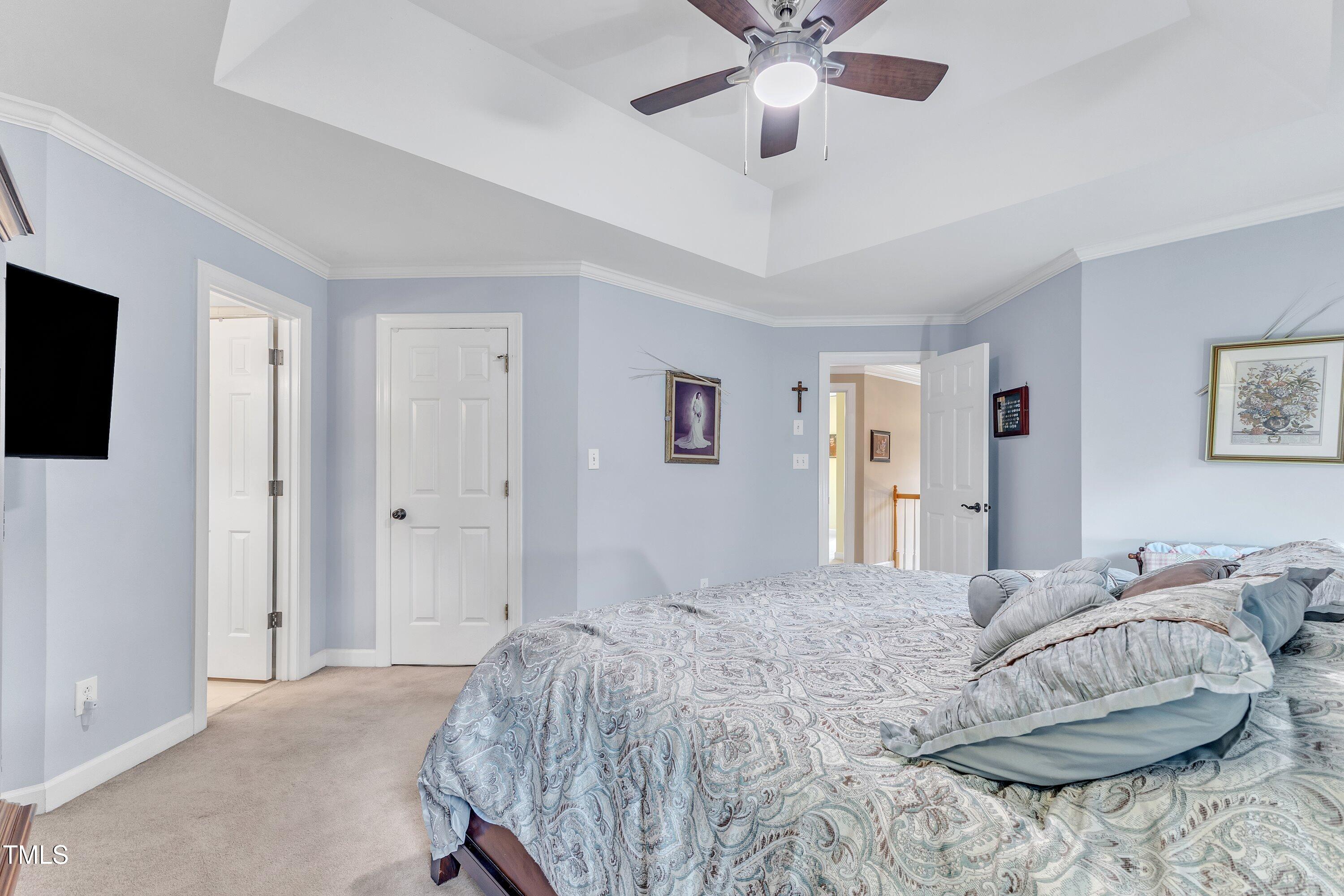 7613 Percy Court Raleigh, NC 27613 - Photo 31 of 51 a bedroom with a bed and a flat screen tv