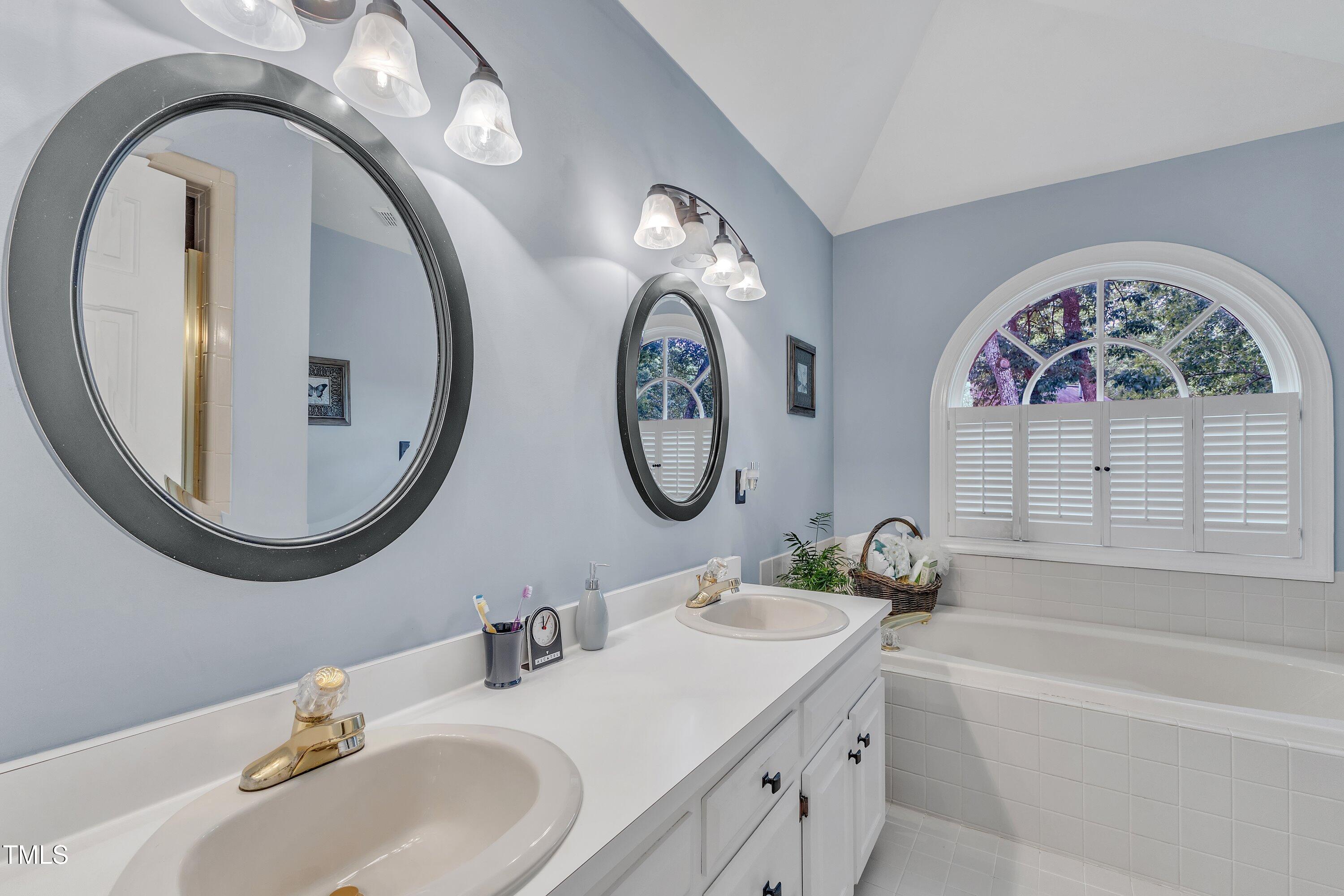7613 Percy Court Raleigh, NC 27613 - Photo 32 of 51 a bathroom with a granite countertop double vanity sink and a mirror