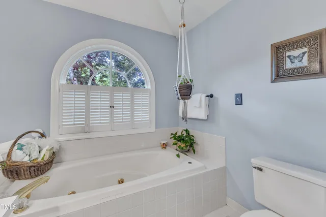 a white bath tub with a window
