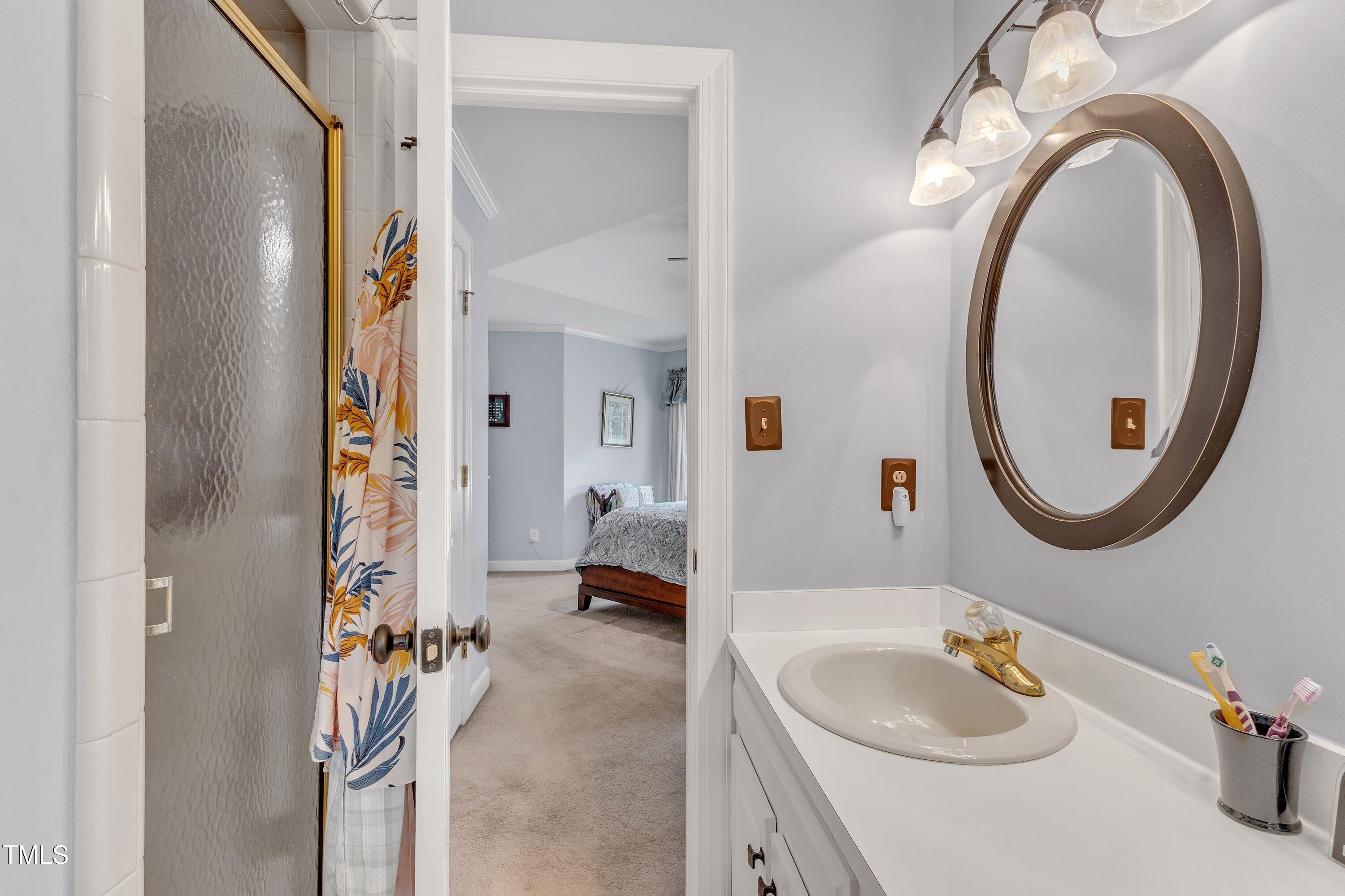 7613 Percy Court Raleigh, NC 27613 - Photo 34 of 51 a bathroom with a sink and a mirror
