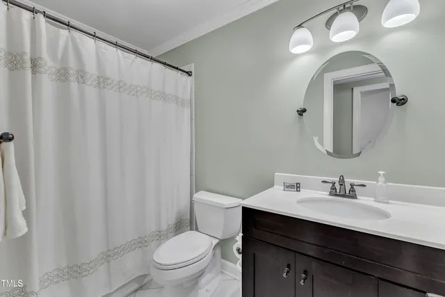 a bathroom with a toilet a sink and a mirror