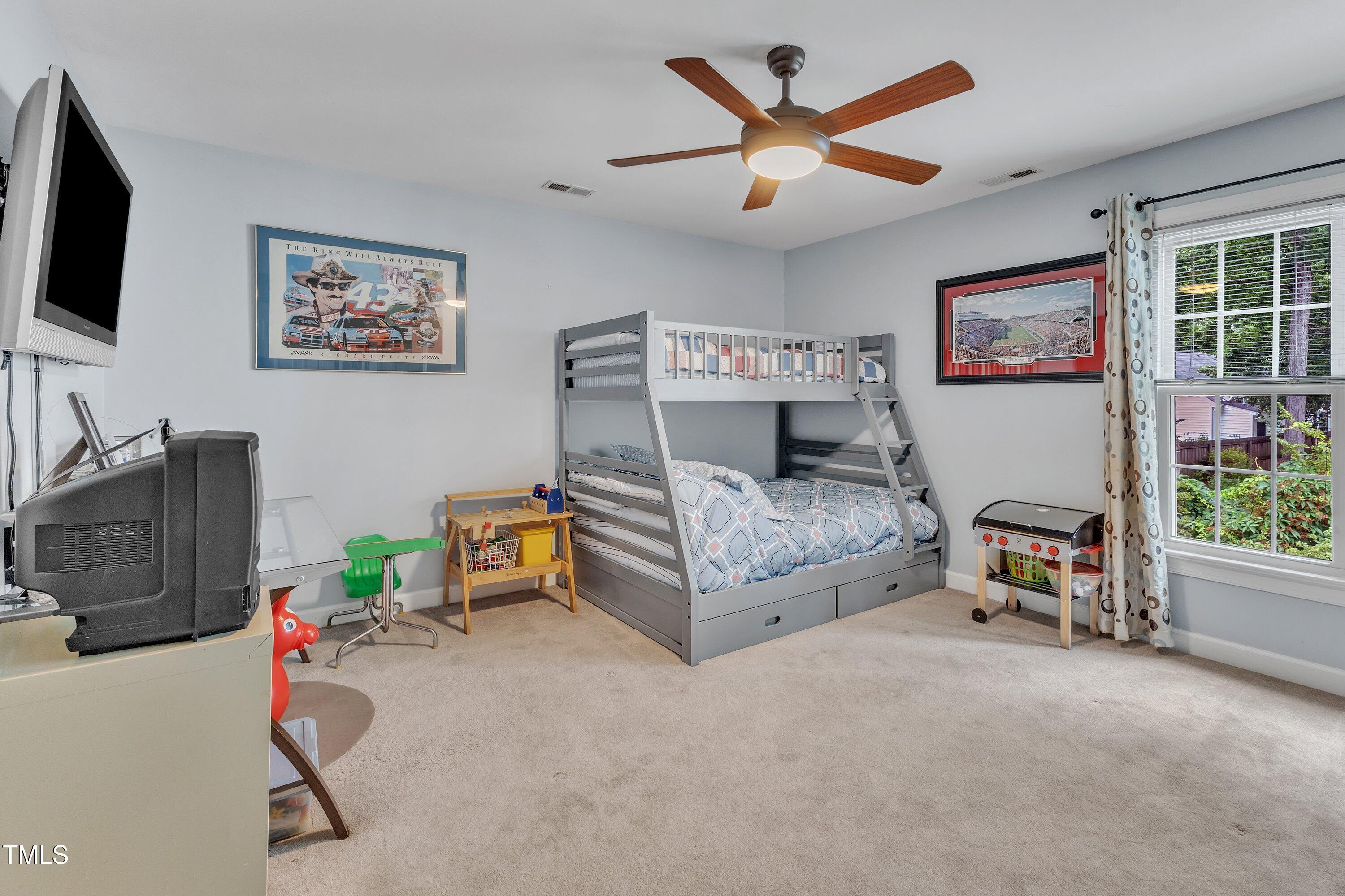 7613 Percy Court Raleigh, NC 27613 - Photo 40 of 51 a living room with furniture and a flat screen tv