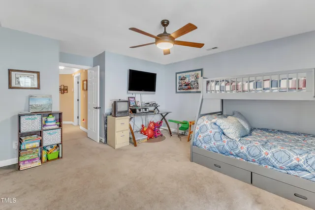 a bedroom with furniture and a flat screen tv
