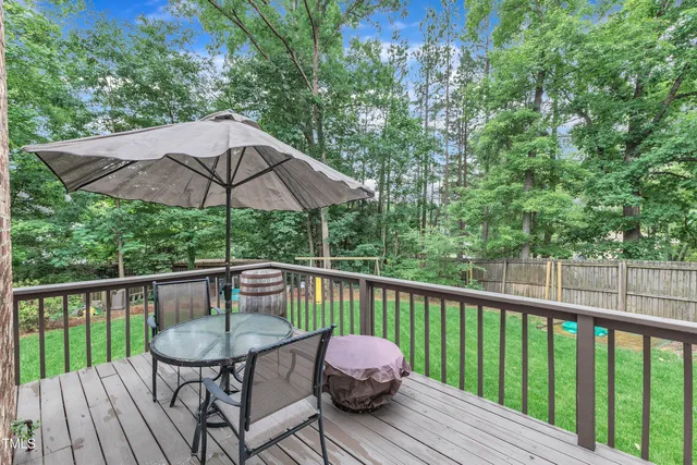 a view of a deck with furniture and barbeque oven