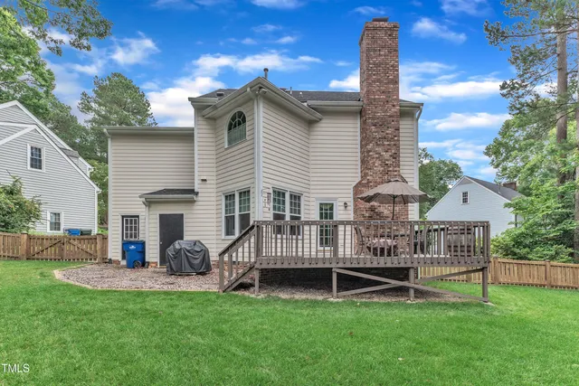 a view of a house with a yard and deck