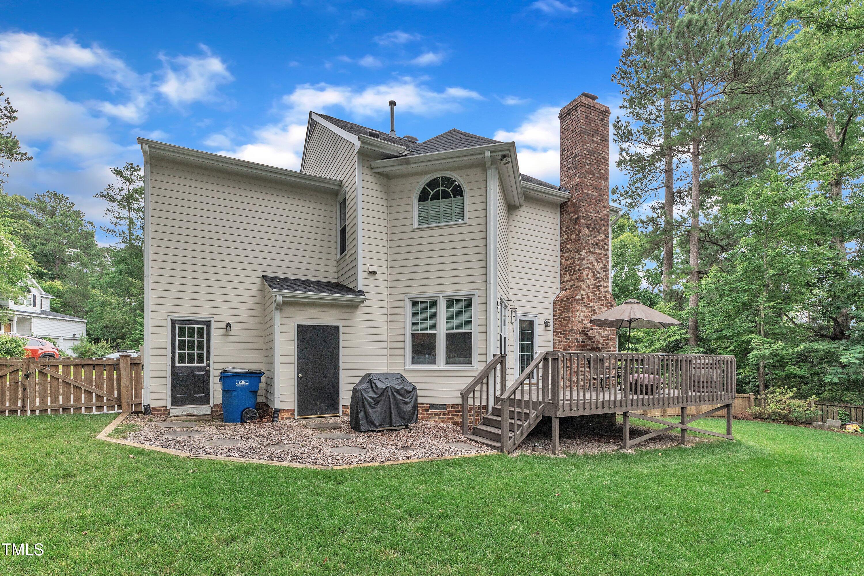 7613 Percy Court Raleigh, NC 27613 - Photo 46 of 51 a backyard of a house with table and chairs with wooden fence