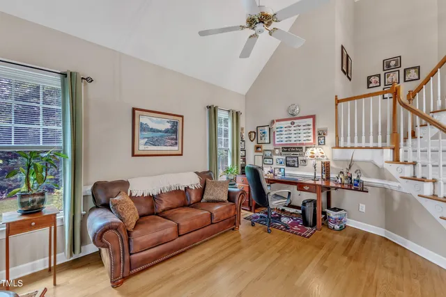 a living room with furniture and wooden floor