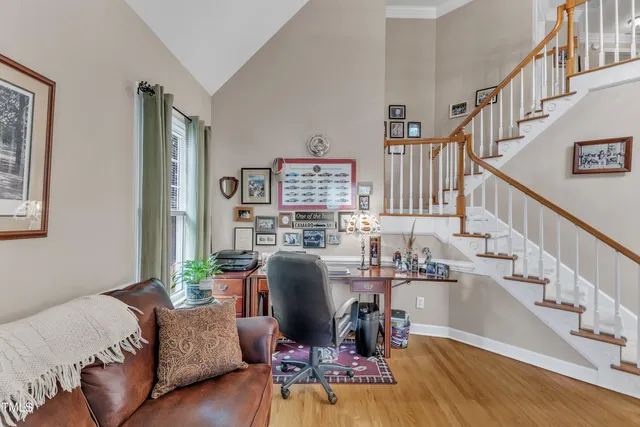 a living room with furniture and a dining table