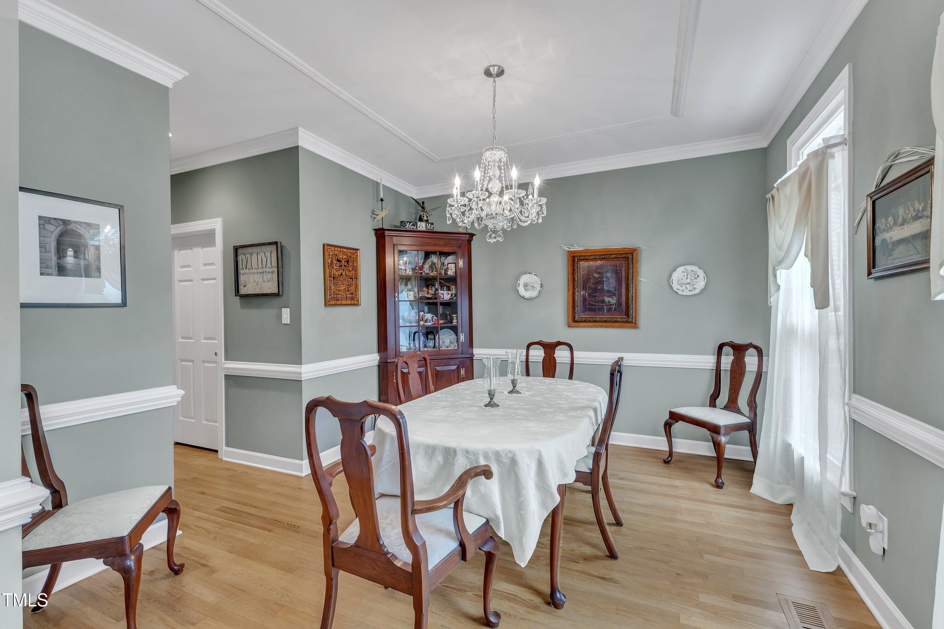 7613 Percy Court Raleigh, NC 27613 - Photo 10 of 51 a view of a dining room with furniture and chandelier