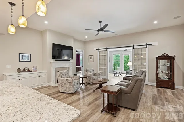 a living room with fireplace furniture and a flat screen tv