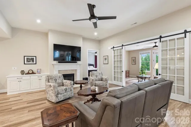 a living room with furniture a fireplace and a flat screen tv