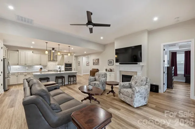 a living room with fireplace furniture and a flat screen tv