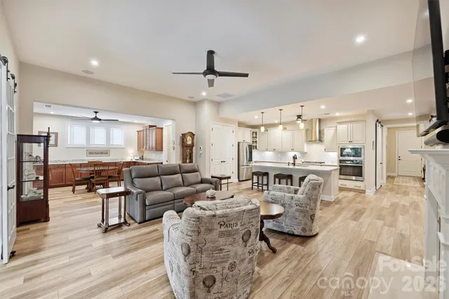 a living room with furniture and kitchen view