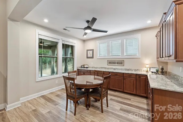 a dining room with granite countertop furniture and wooden floor