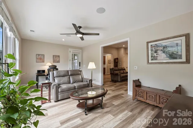 a living room with furniture and a wooden floor