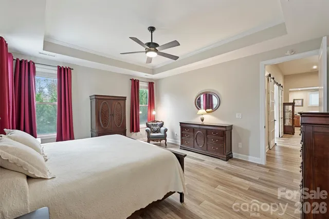 a bedroom with a bed and a chandelier