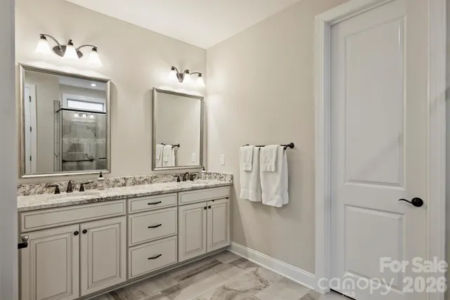 a bathroom with a double vanity sink and mirror